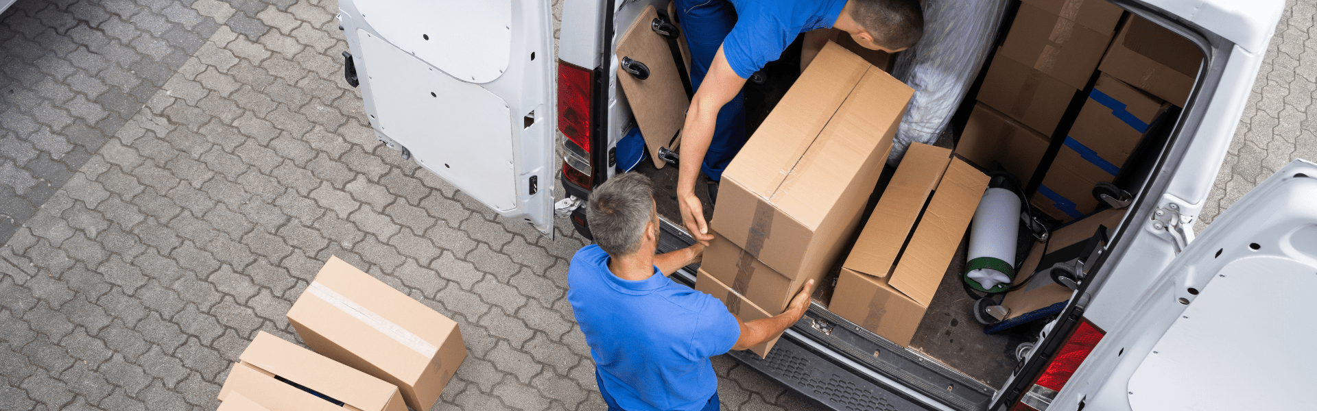 package delivery tuck with two people loading packages into back