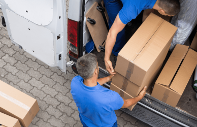 package delivery tuck with two people loading packages into back