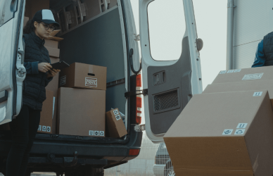 Delivery drivers packing delivery van with boxes