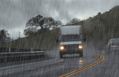 delivery truck on rainy road strategies to overcome weather delays in last-mile delivery.
